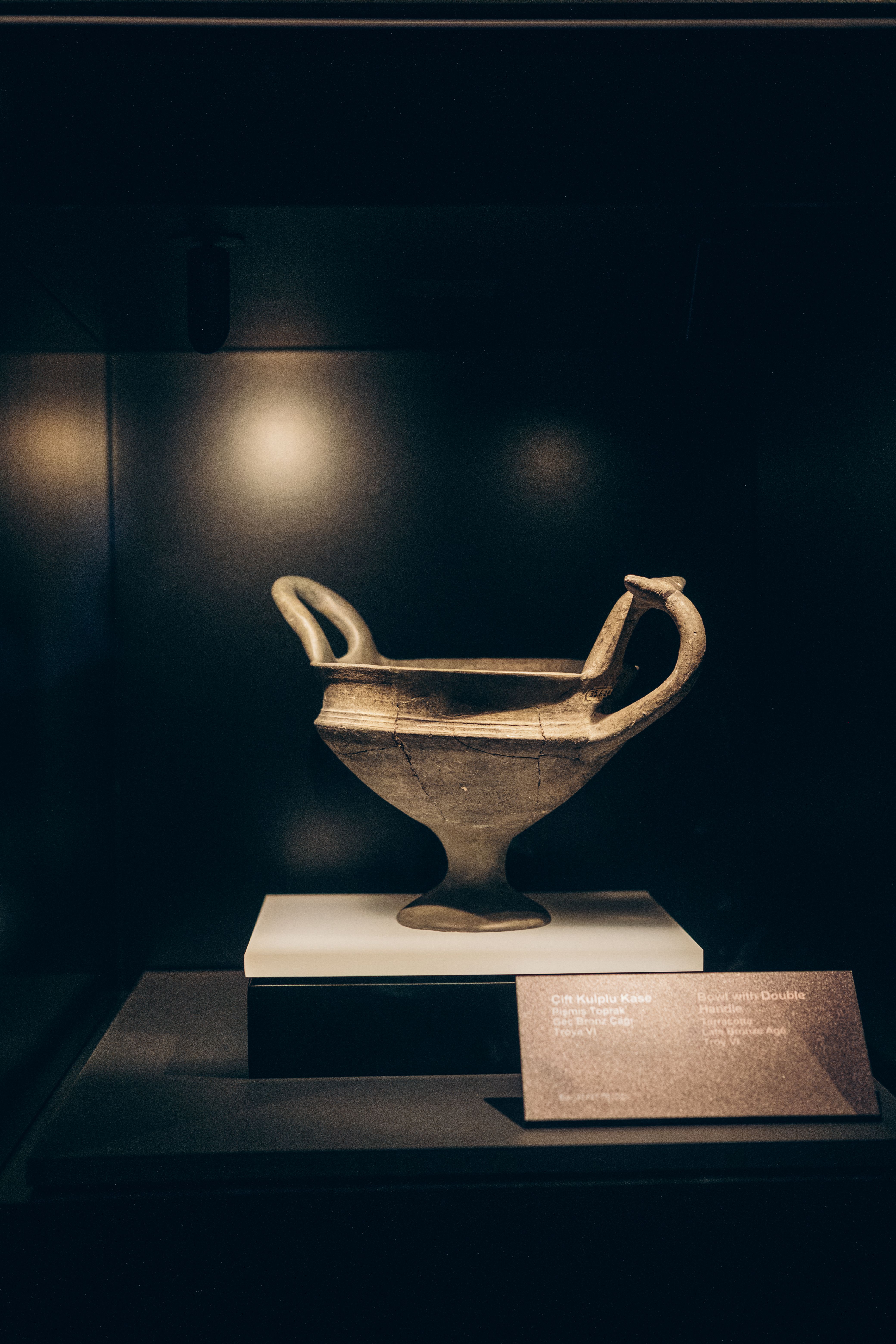 Ancient double-handled pottery on display at an archaeology museum
